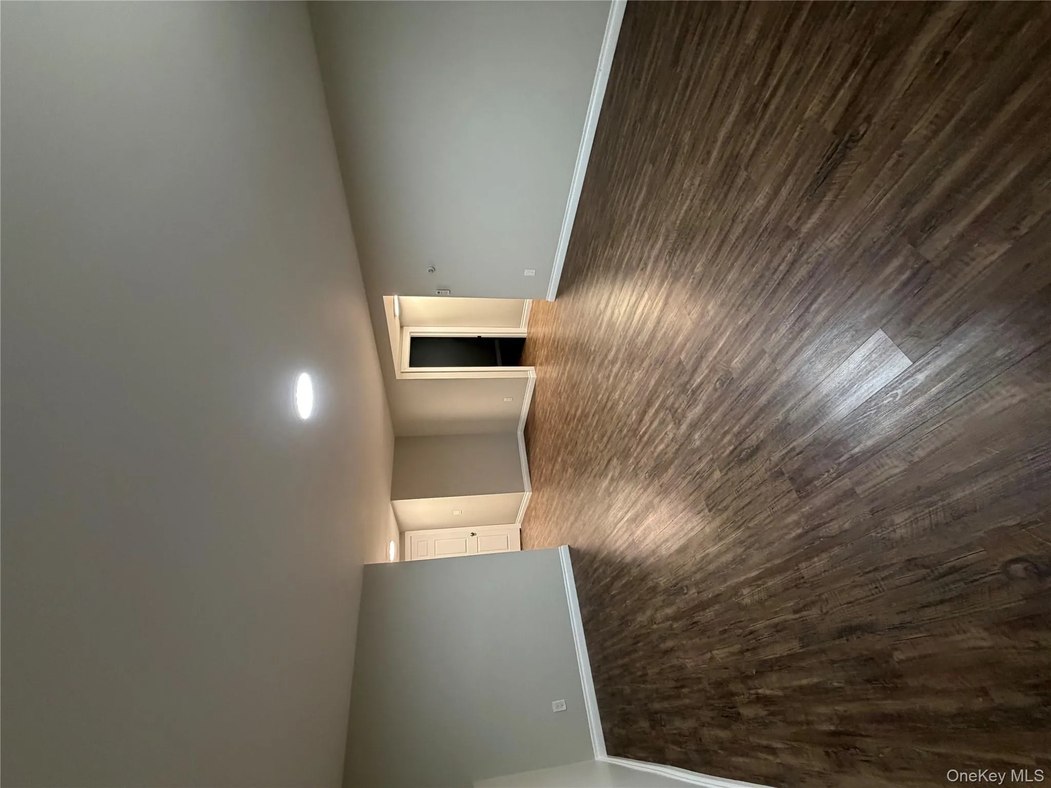 Empty room featuring baseboards and dark wood-style floors Empty room featuring baseboards and dark wood-style floors