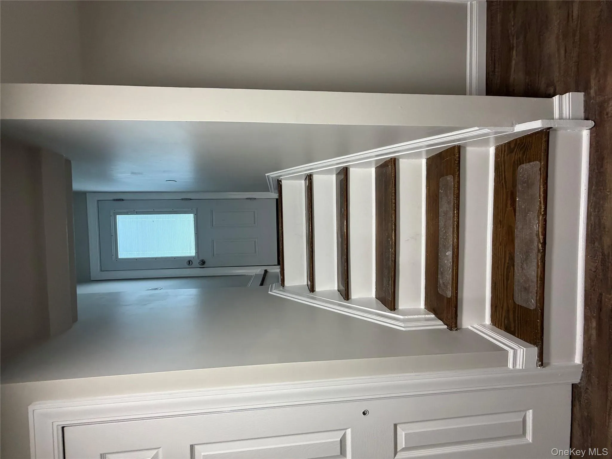 Stairway featuring baseboards and wood finished floors Stairway featuring baseboards and wood finished floors