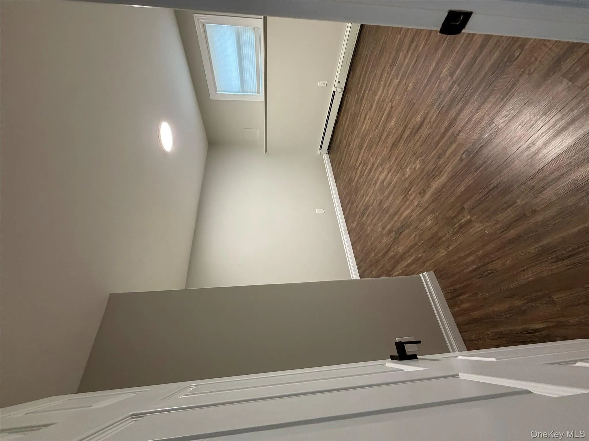 Spare room with dark wood finished floors and baseboard heating Spare room with dark wood finished floors and baseboard heating