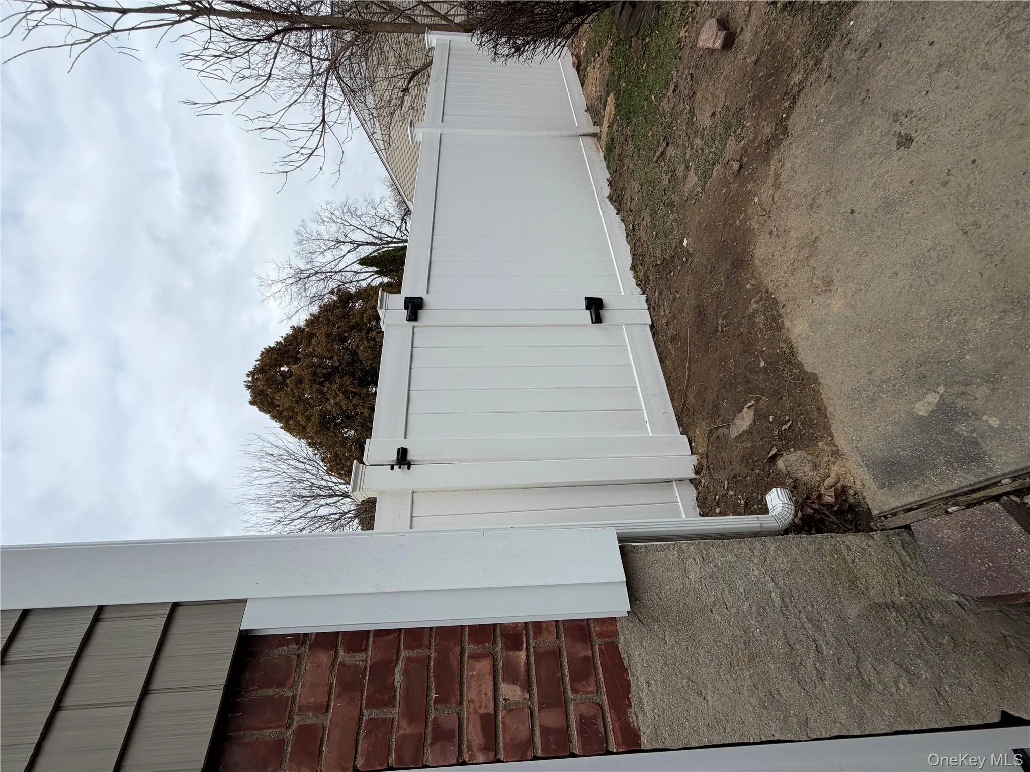 View of yard featuring a gate View of yard featuring a gate
