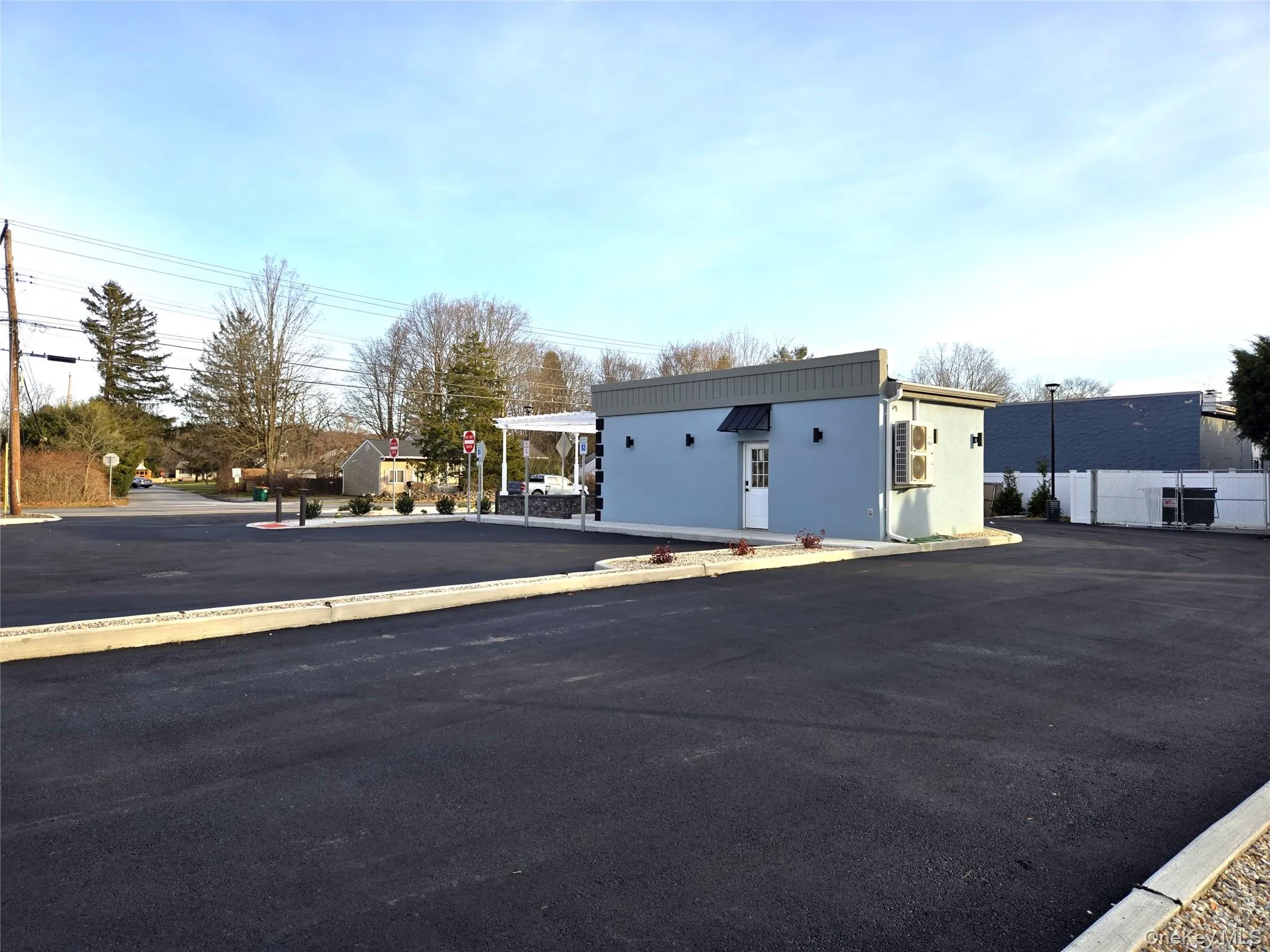 View of asphalt road with curbs and traffic signs View of asphalt road with curbs and traffic signs
