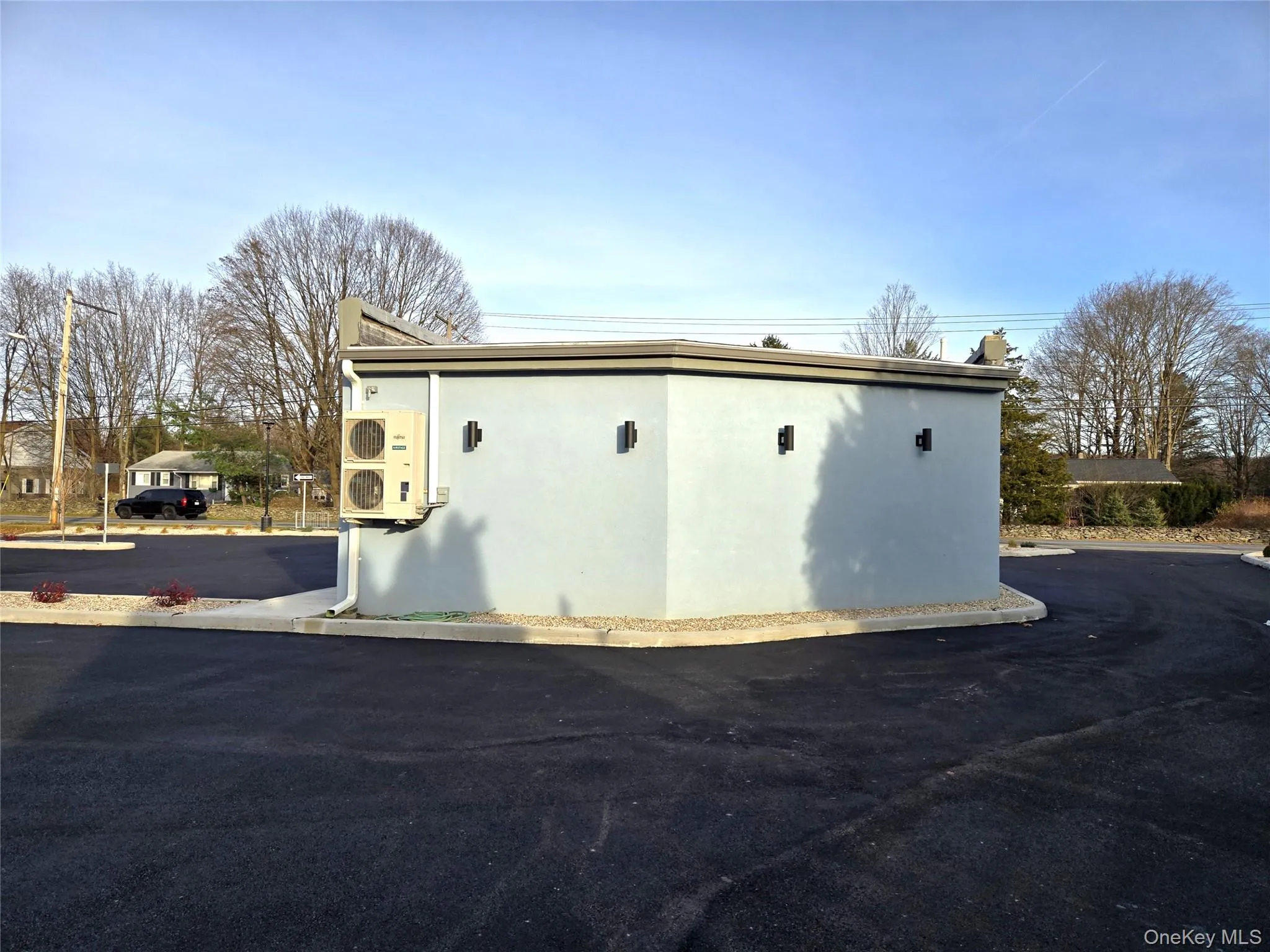 View of side of property with stucco siding and an ac unit View of side of property with stucco siding and an ac unit