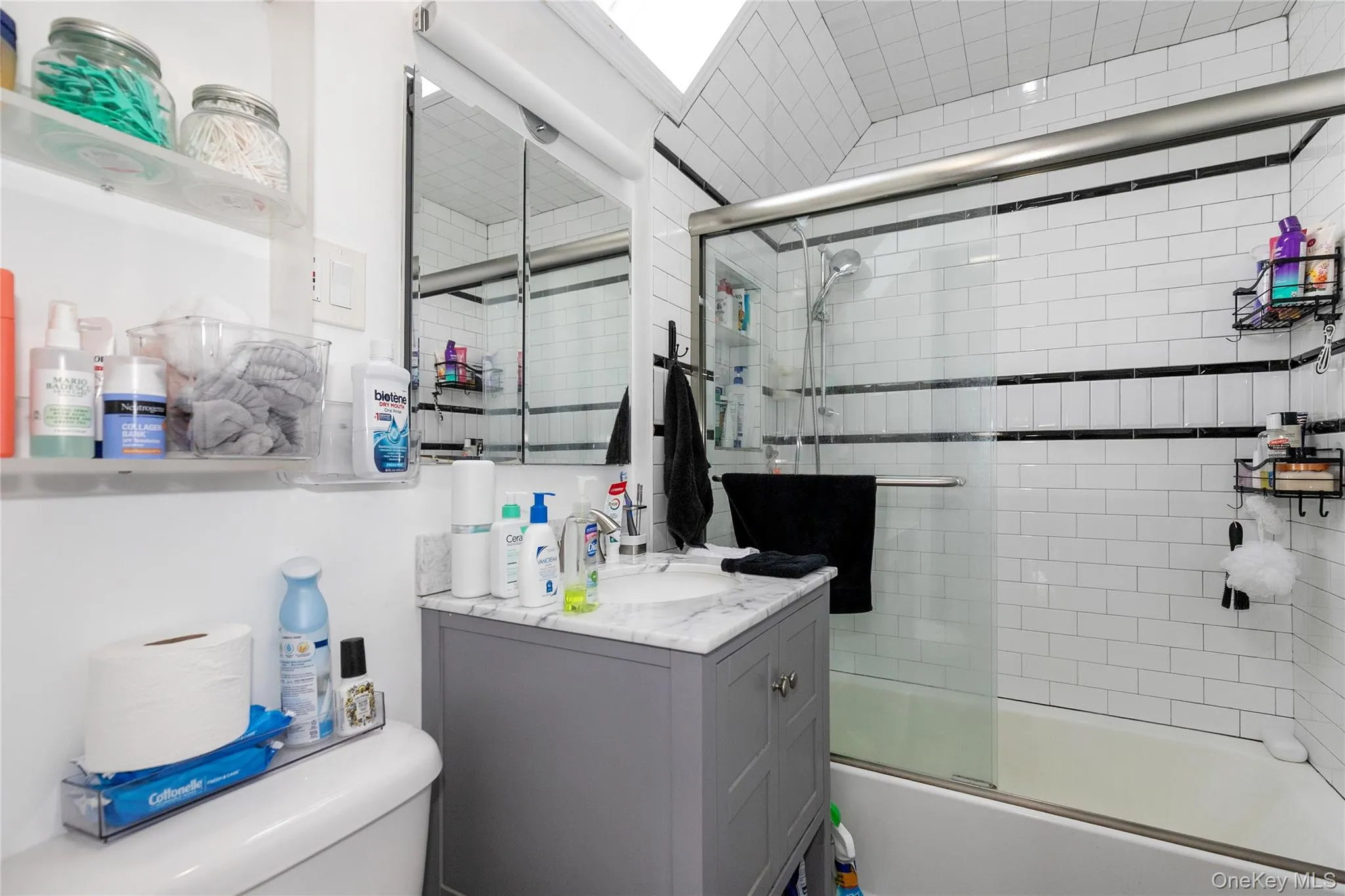 Full bathroom with vanity and bath / shower combo with glass door Full bathroom with vanity and bath / shower combo with glass door