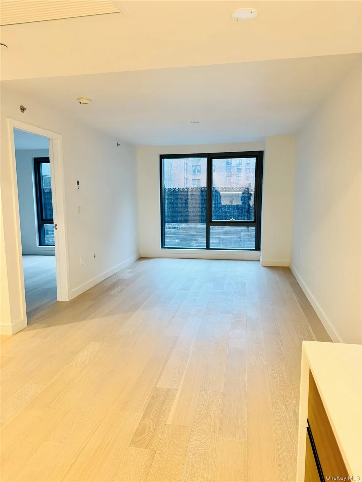 Spare room featuring light wood-style floors and baseboards Spare room featuring light wood-style floors and baseboards