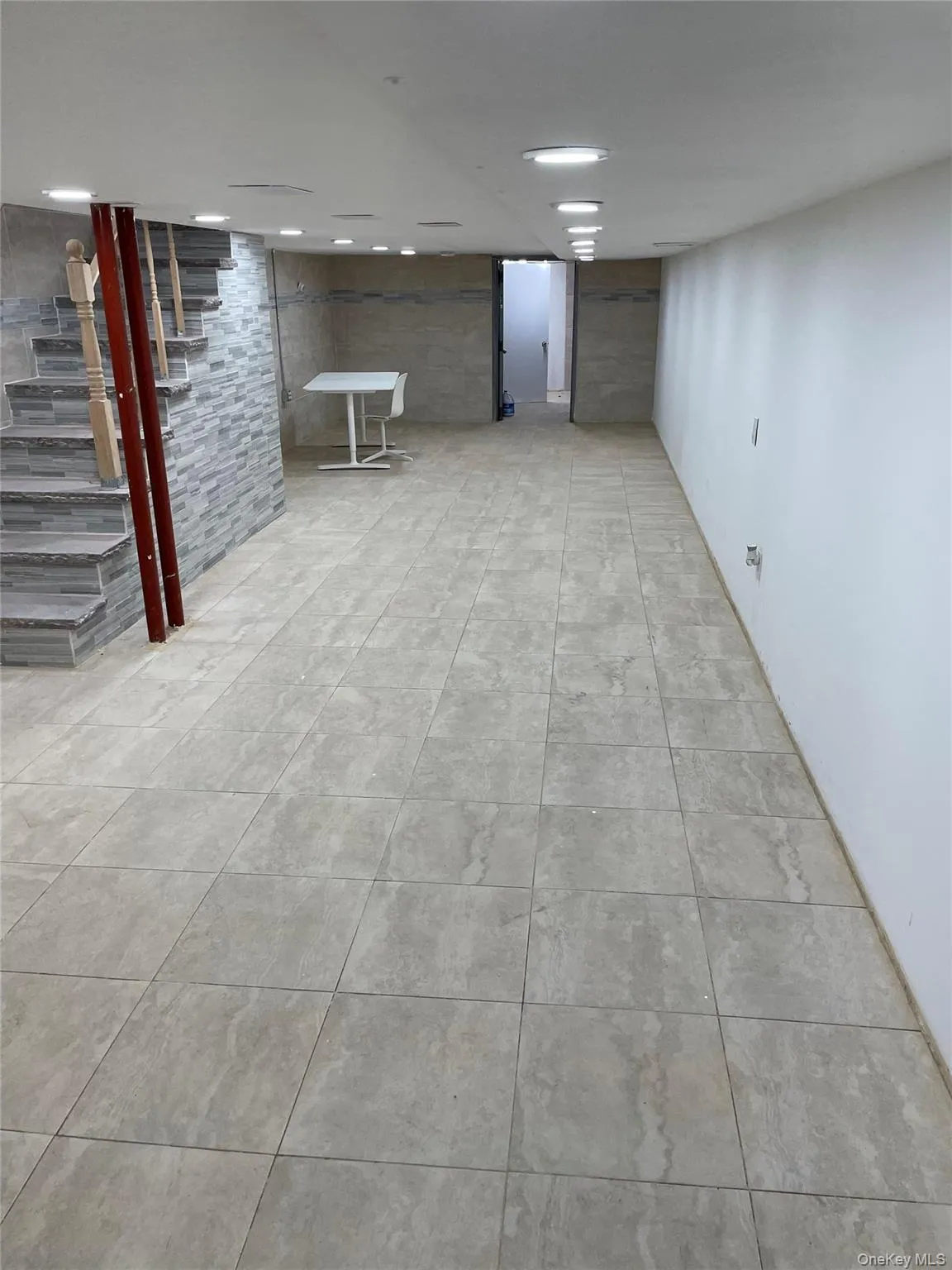 Finished below grade area featuring light tile patterned floors Finished below grade area featuring light tile patterned floors