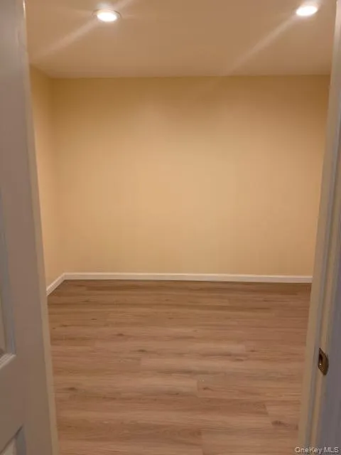 Spare room featuring recessed lighting and wood finished floors Spare room featuring recessed lighting and wood finished floors