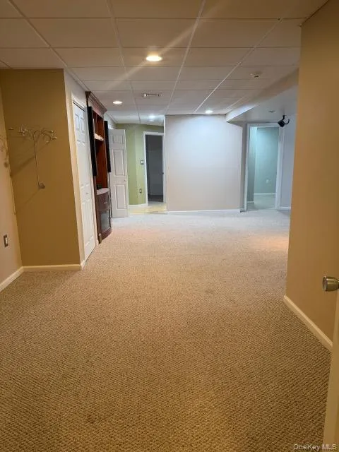 Unfurnished room featuring light colored carpet, a drop ceiling, and recessed lighting Unfurnished room featuring light colored carpet, a drop ceiling, and recessed lighting