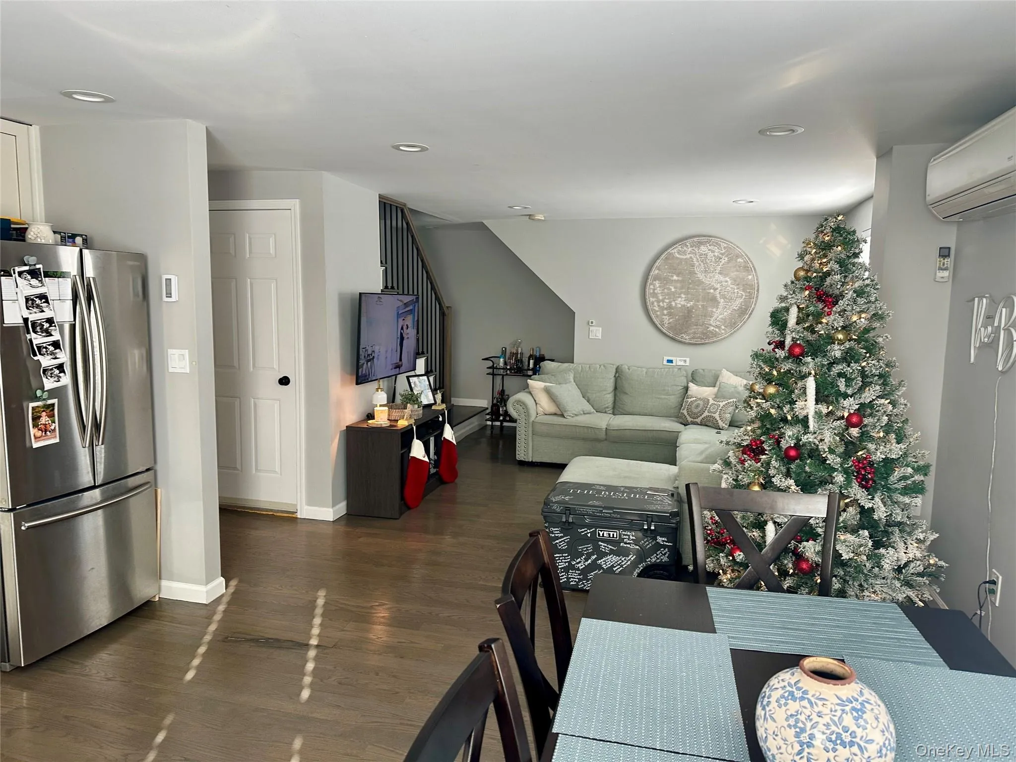 Dining area featuring dark wood-style flooring, recessed lighting, a wall mounted AC, and stairway Dining area featuring dark wood-style flooring, recessed lighting, a wall mounted AC, and stairway