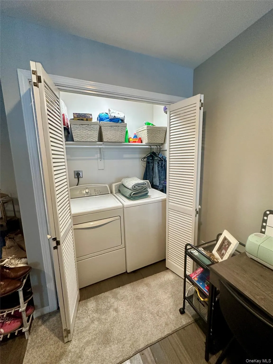 Washroom featuring separate washer and dryer, a textured ceiling, and light wood-style flooring Washroom featuring separate washer and dryer, a textured ceiling, and light wood-style flooring