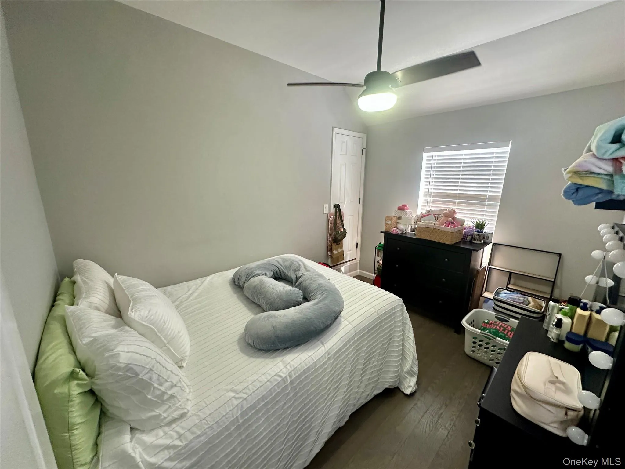 Bedroom with dark wood-type flooring and a ceiling fan Bedroom with dark wood-type flooring and a ceiling fan