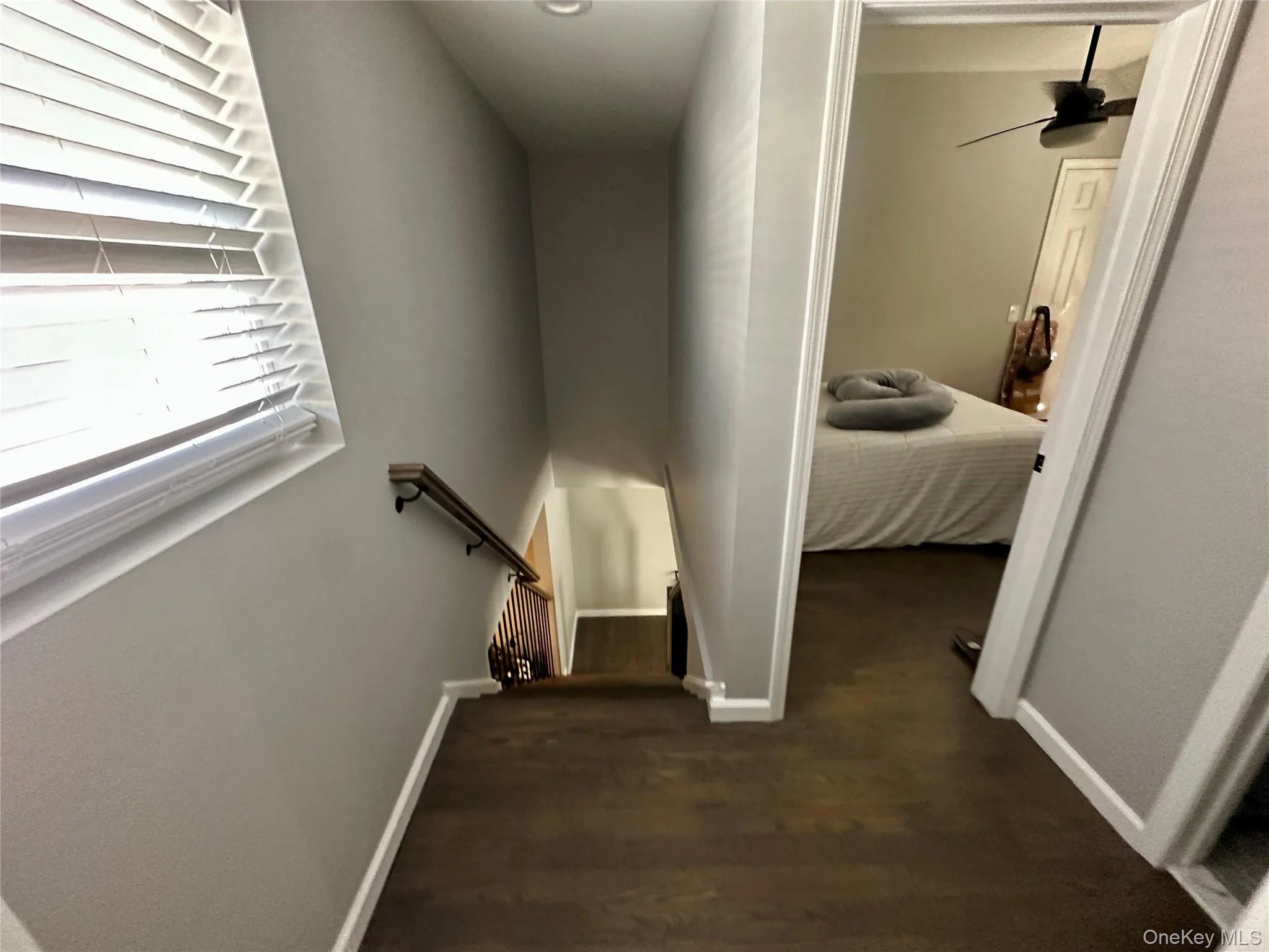 Hallway with dark wood-style flooring and an upstairs landing Hallway with dark wood-style flooring and an upstairs landing