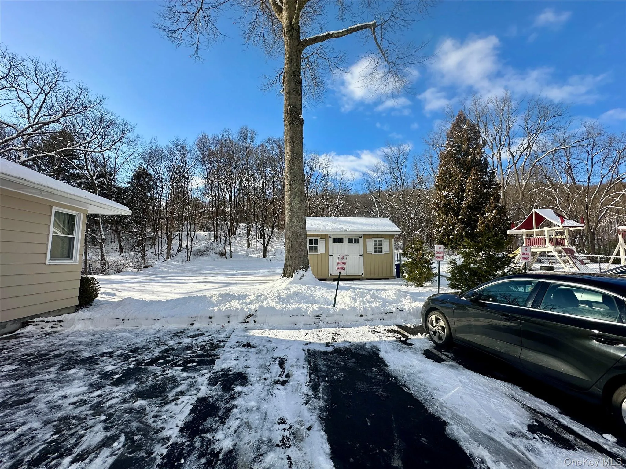 Yard covered in snow featuring an outdoor structure Yard covered in snow featuring an outdoor structure