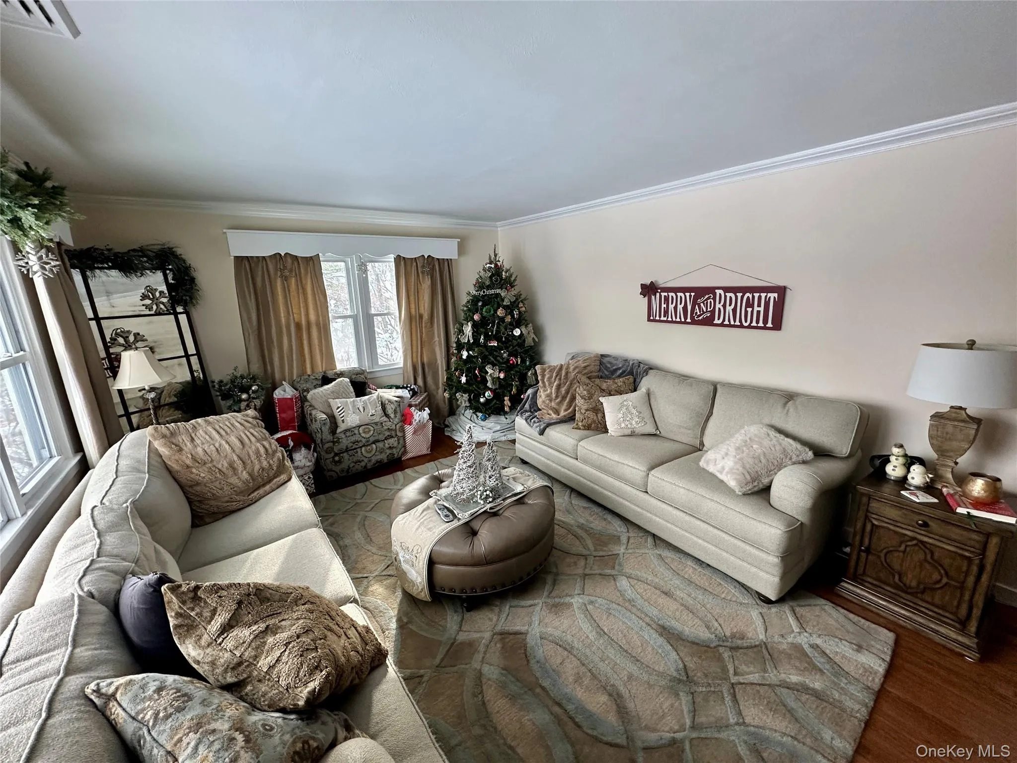 Living area with wood finished floors and ornamental molding Living area with wood finished floors and ornamental molding