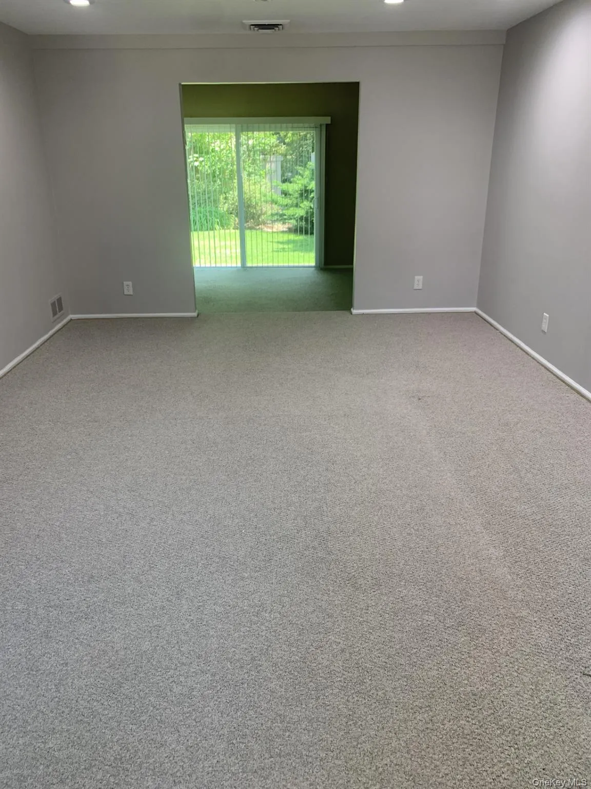 Living room featuring light carpet and recessed lighting Living room featuring light carpet and recessed lighting