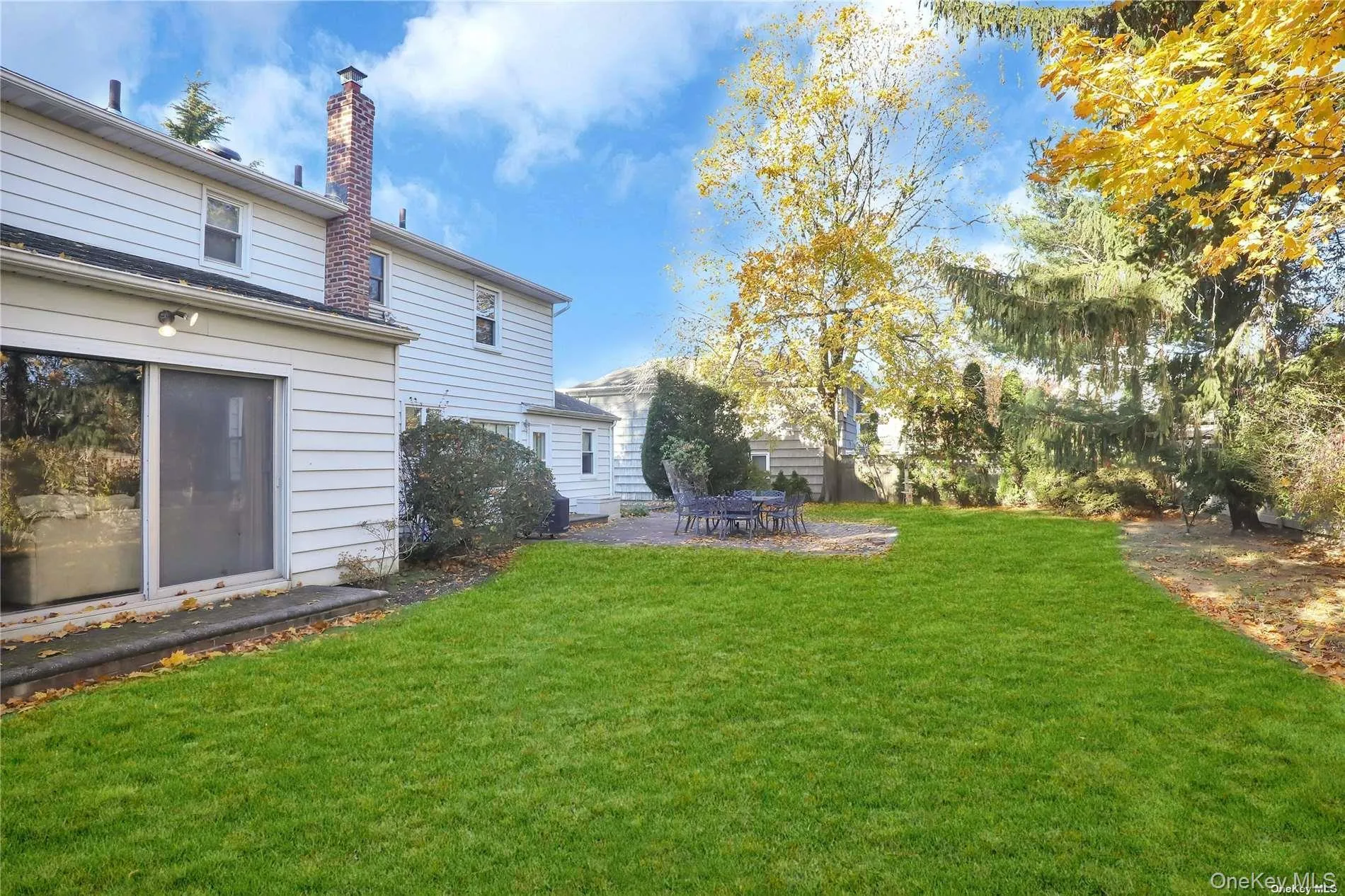 View of grassy yard featuring a patio View of grassy yard featuring a patio