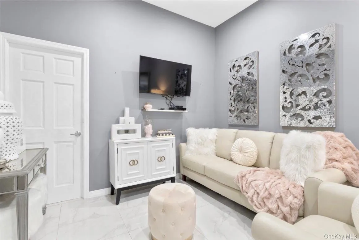 Living room with light marble finish flooring and baseboards Living room with light marble finish flooring and baseboards