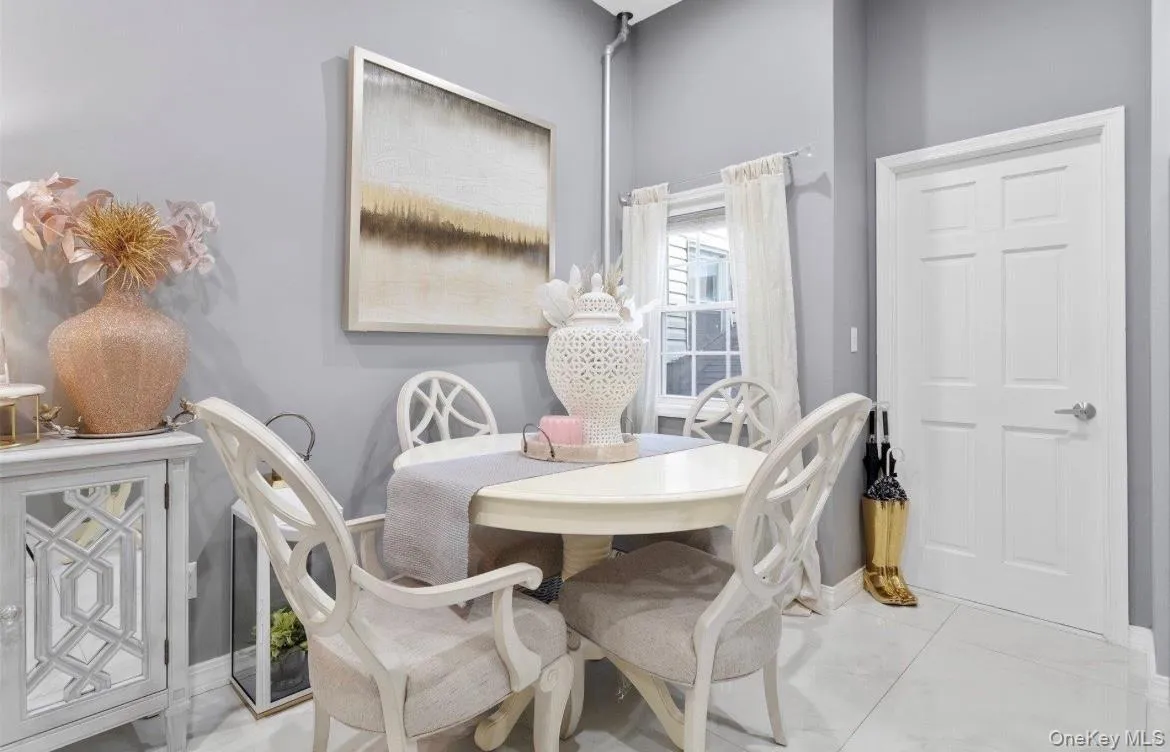 Dining space featuring baseboards and light tile patterned flooring Dining space featuring baseboards and light tile patterned flooring