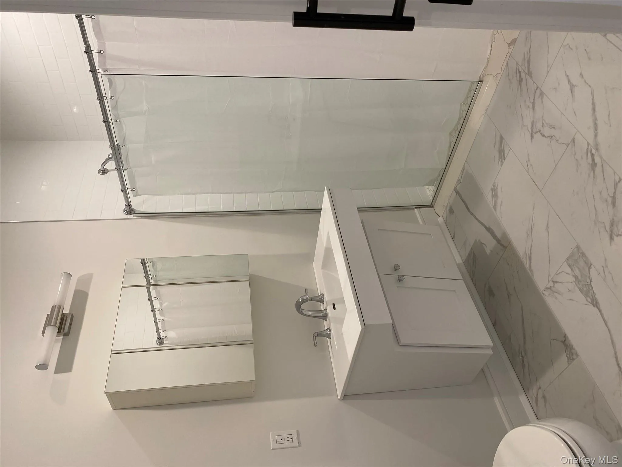 Bathroom with a stall shower, light marble finish floors, and vanity Bathroom with a stall shower, light marble finish floors, and vanity