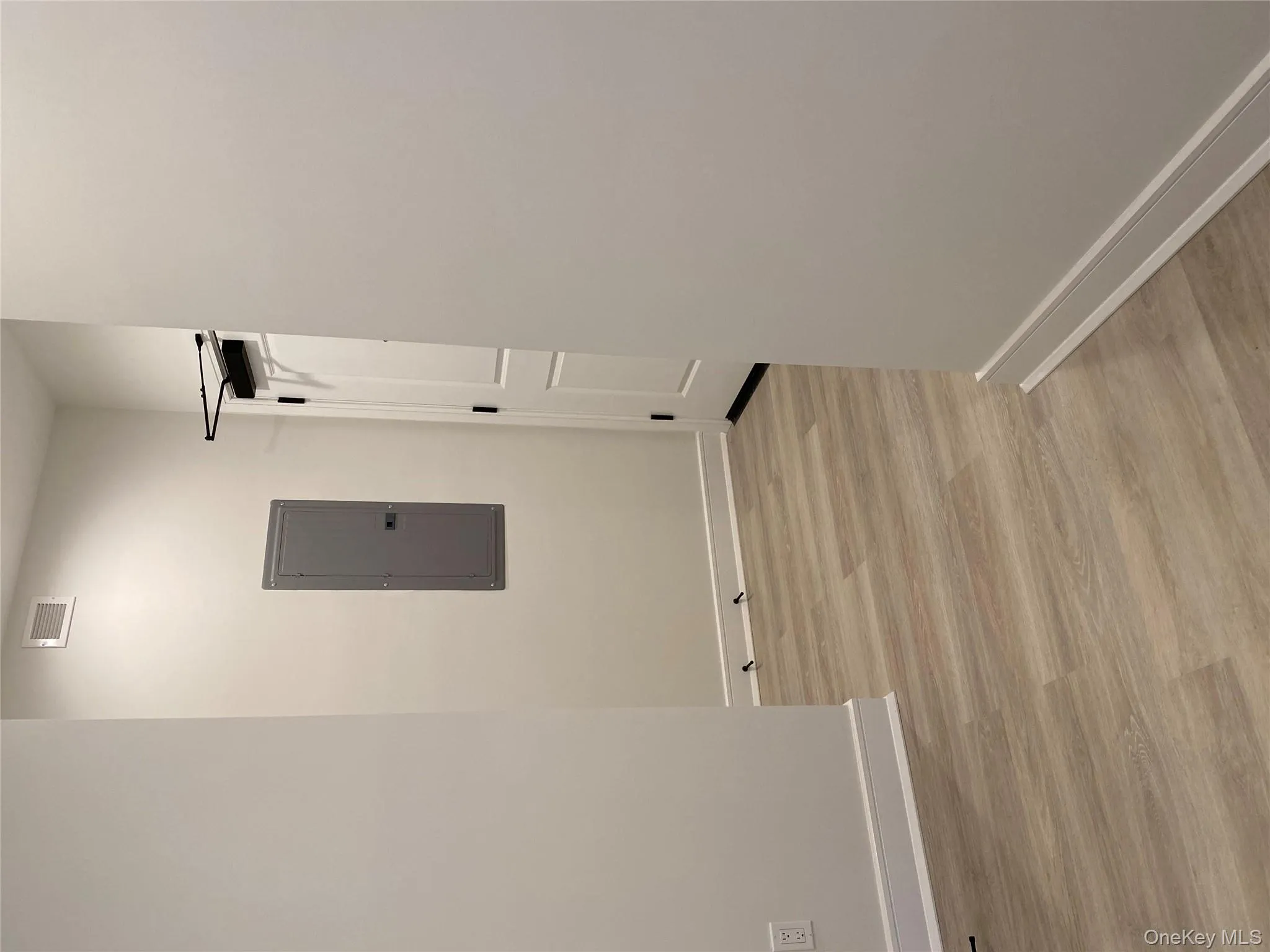 Hall with electric panel and light wood-style floors Hall with electric panel and light wood-style floors