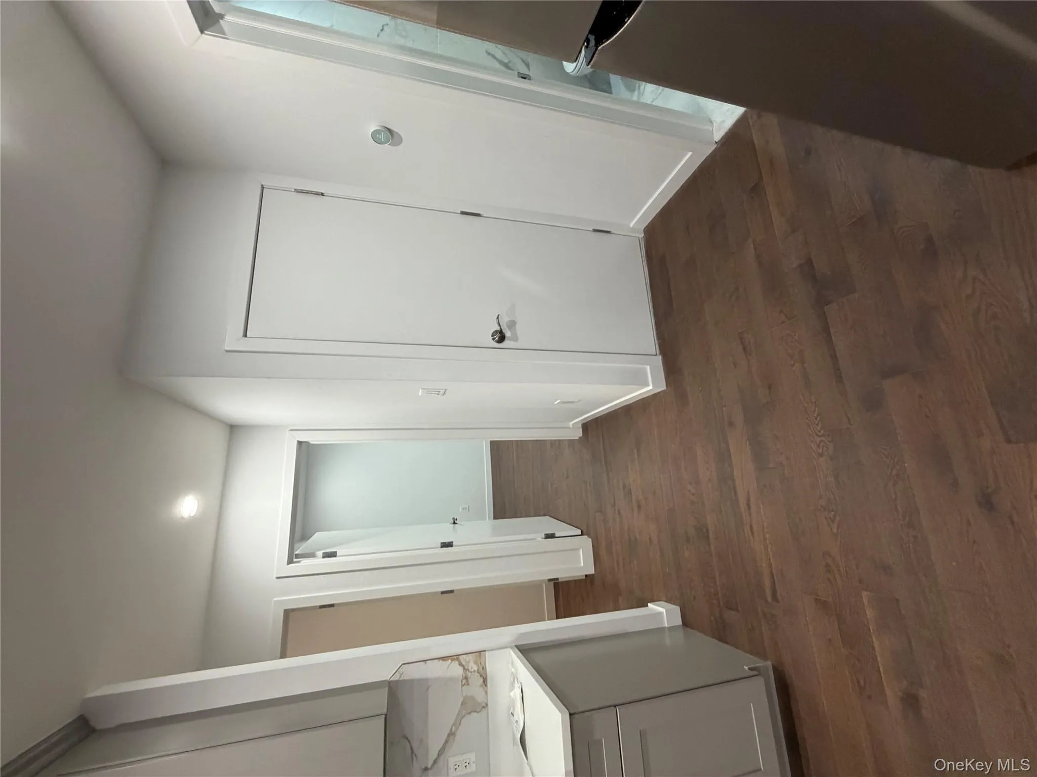 Hall with dark wood-type flooring and recessed lighting Hall with dark wood-type flooring and recessed lighting