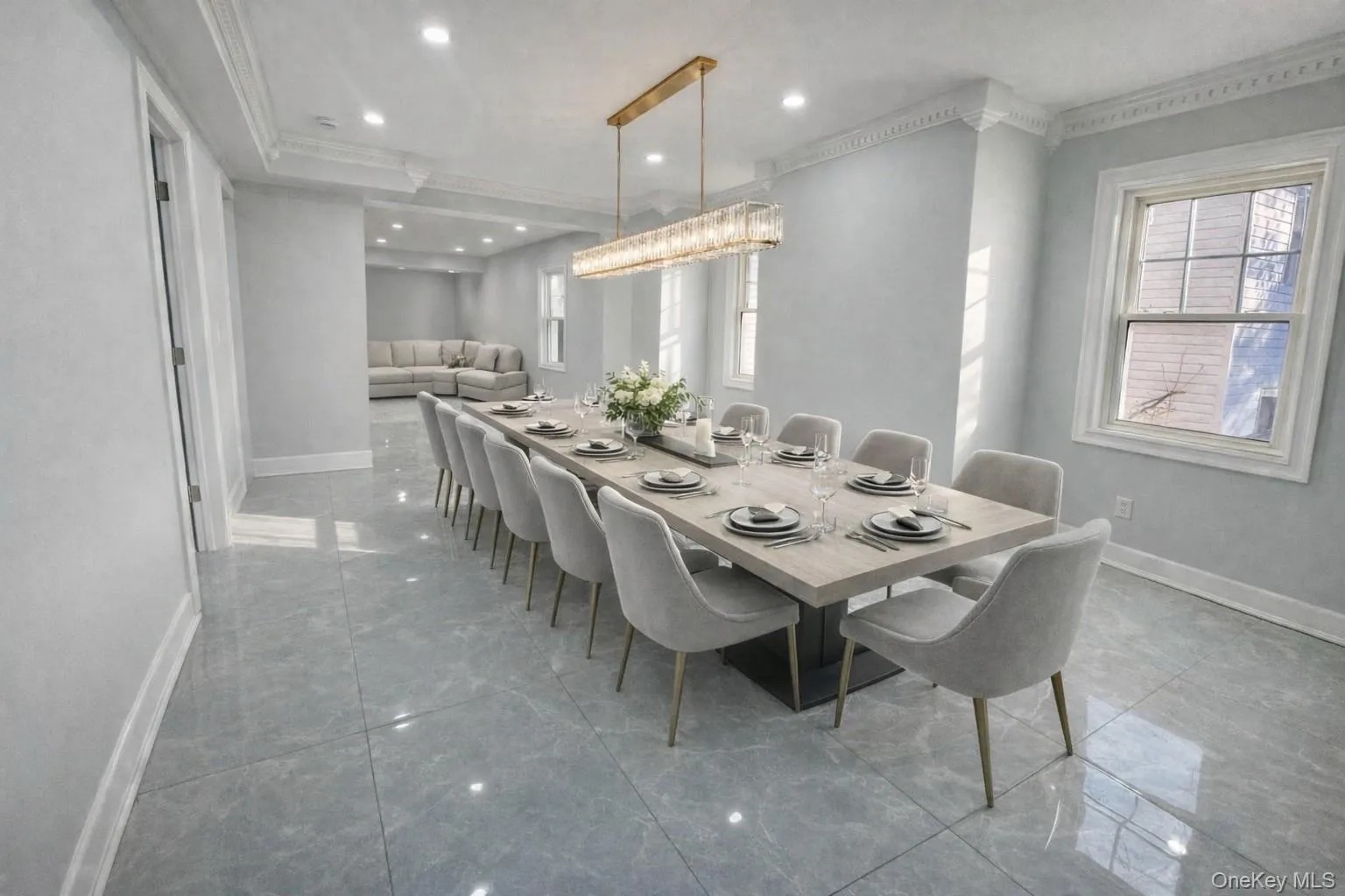Staged Dining room featuring crown molding, recessed lighting, light marble finish floors, and a chandelier Staged Dining room featuring crown molding, recessed lighting, light marble finish floors, and a chandelier