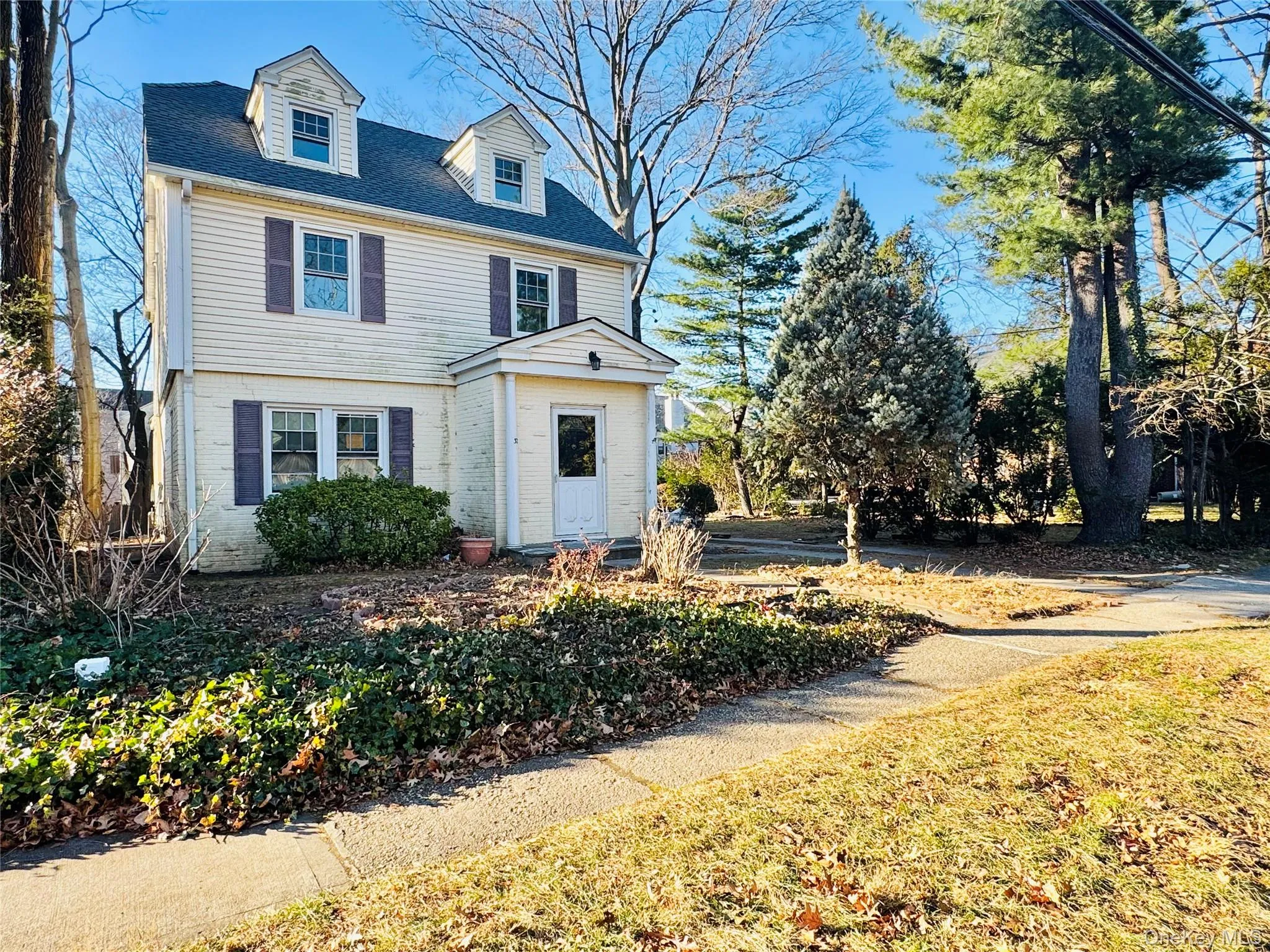 View of front of property with brick siding and a shingled roof View of front of property with brick siding and a shingled roof