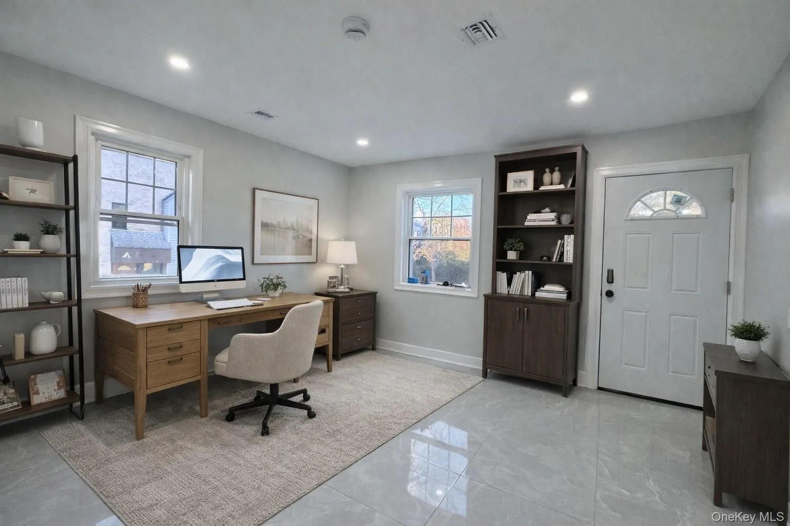 Home office with light marble finish floors and baseboards Home office with light marble finish floors and baseboards