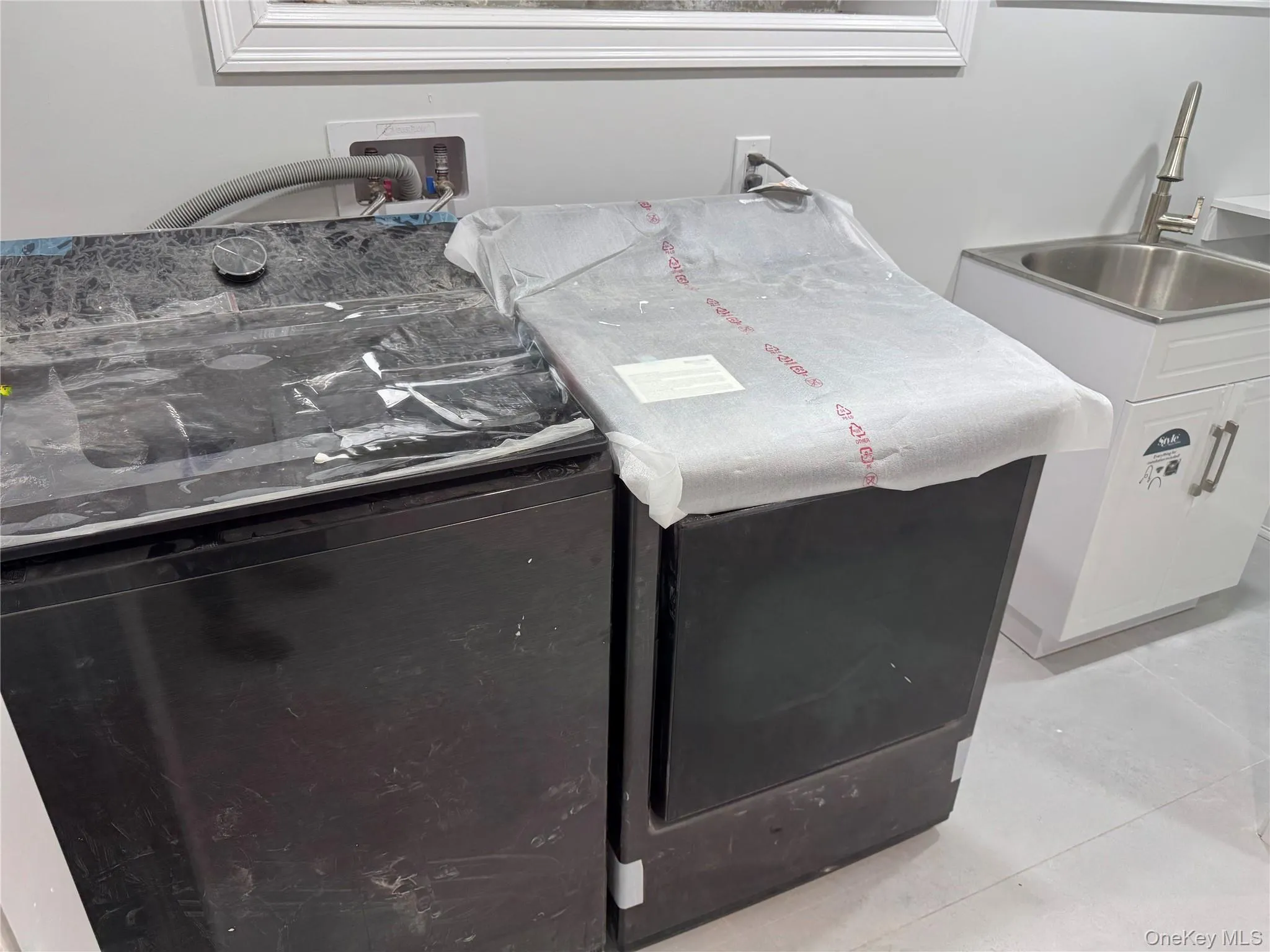 Laundry with washer / dryer and a sink Laundry with washer / dryer and a sink