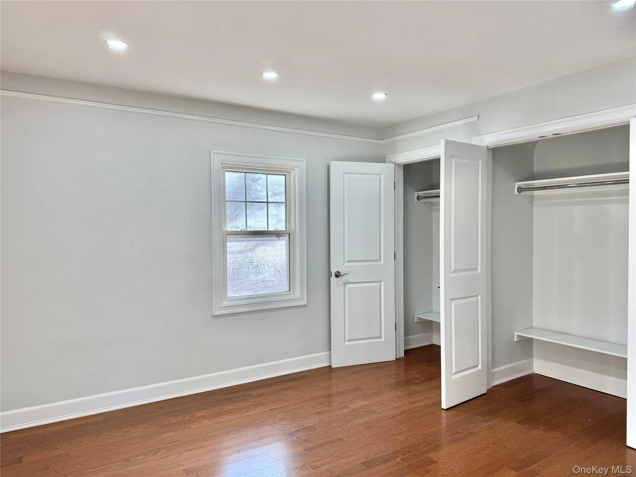 Second Bedroom featuring dark wood-type flooring, a closet, and recessed lighting Second Bedroom featuring dark wood-type flooring, a closet, and recessed lighting