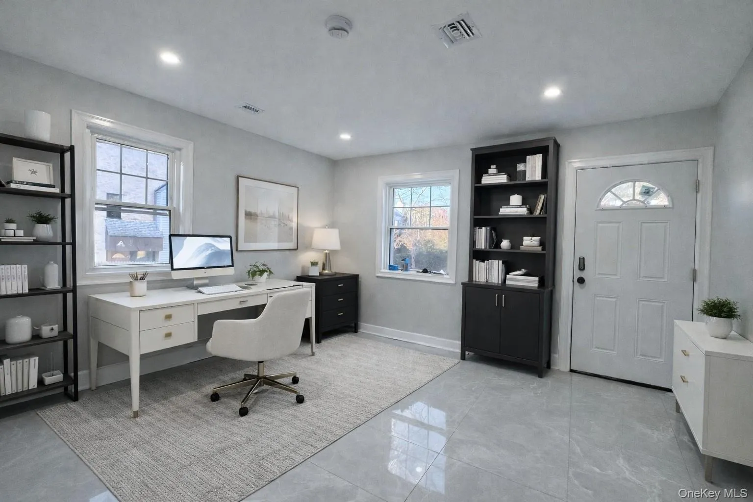 Staged Office space with light marble finish flooring and recessed lighting Staged Office space with light marble finish flooring and recessed lighting