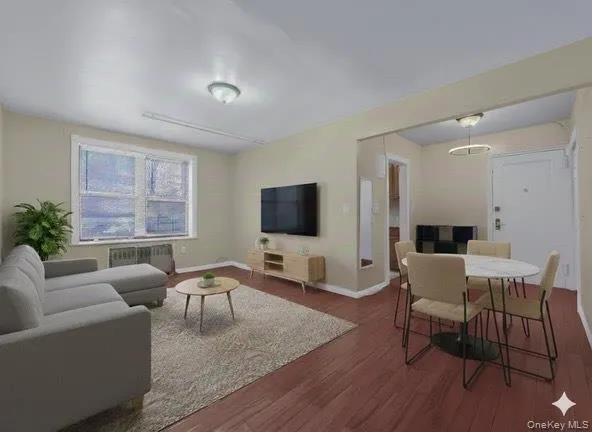 Living room featuring hardwood / wood-style floors and radiator Living room featuring hardwood / wood-style floors and radiator