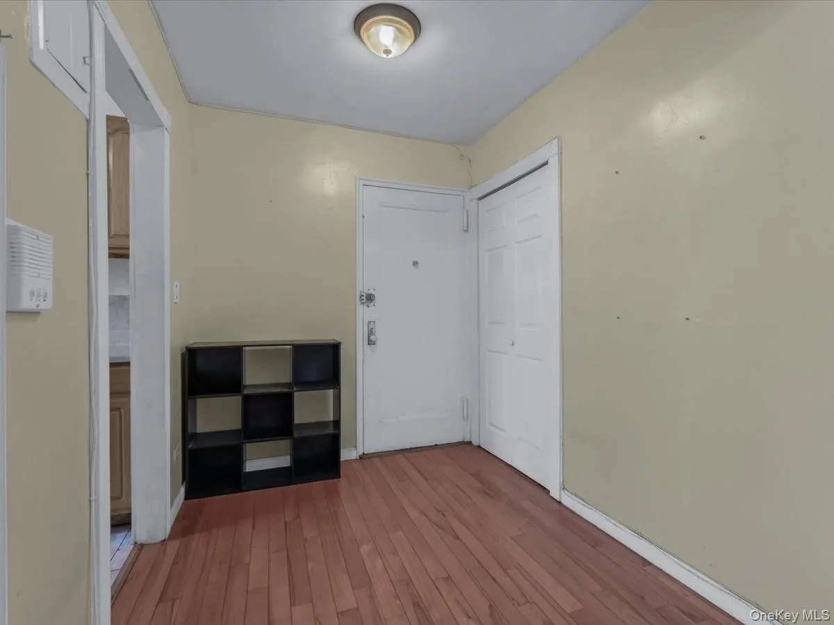 Corridor with hardwood / wood-style flooring and baseboards Corridor with hardwood / wood-style flooring and baseboards