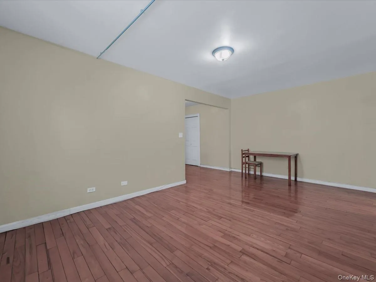 Empty room featuring wood finished floors and baseboards Empty room featuring wood finished floors and baseboards