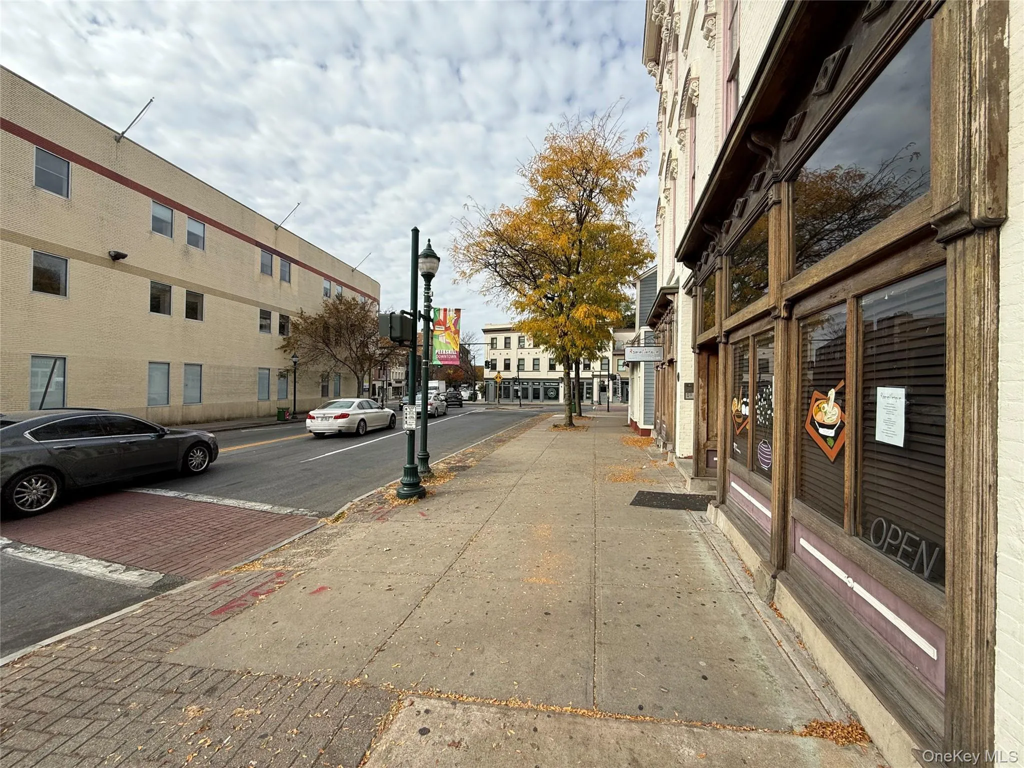 View of street featuring curbs, street lighting, and sidewalks View of street featuring curbs, street lighting, and sidewalks