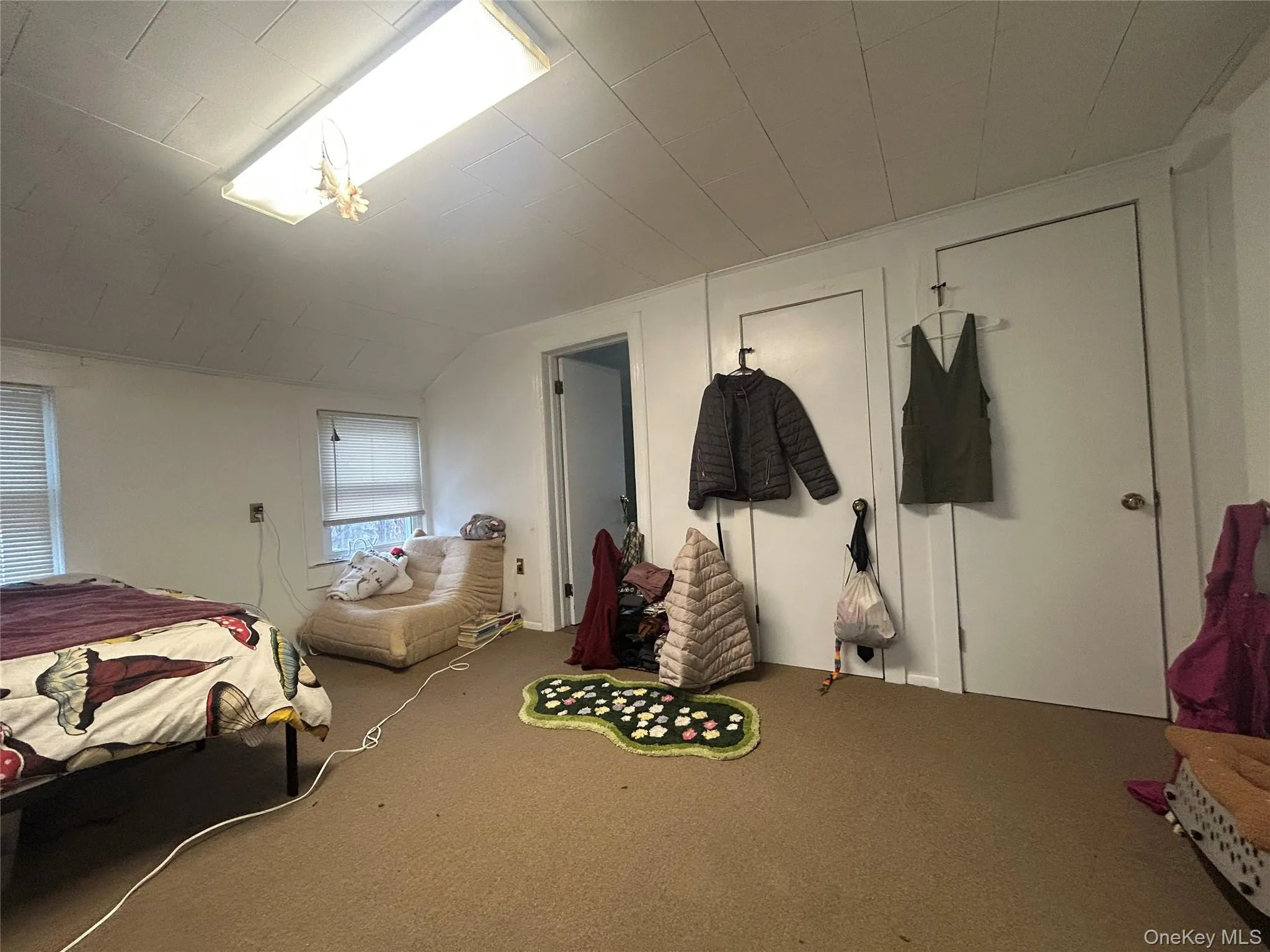 Bedroom featuring carpet floors and lofted ceiling Bedroom featuring carpet floors and lofted ceiling