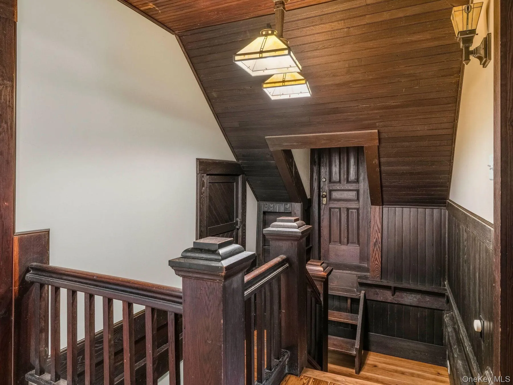 Stairway with wood ceiling, wood finished floors, wood walls, and wainscoting Stairway with wood ceiling, wood finished floors, wood walls, and wainscoting