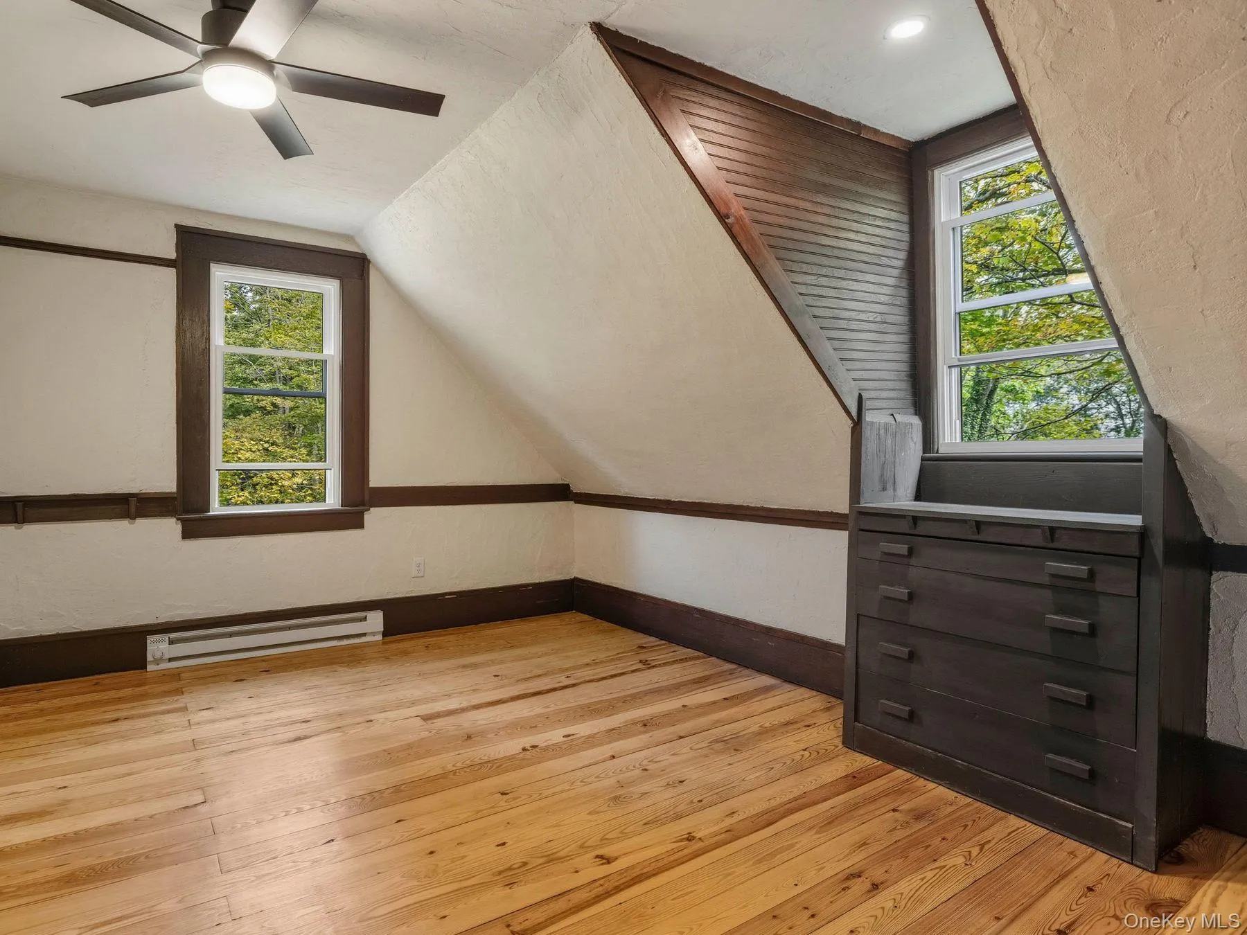 Bonus room featuring light wood-style flooring, a baseboard radiator, plenty of natural light, vaulted ceiling, and a ceiling fan Bonus room featuring light wood-style flooring, a baseboard radiator, plenty of natural light, vaulted ceiling, and a ceiling fan