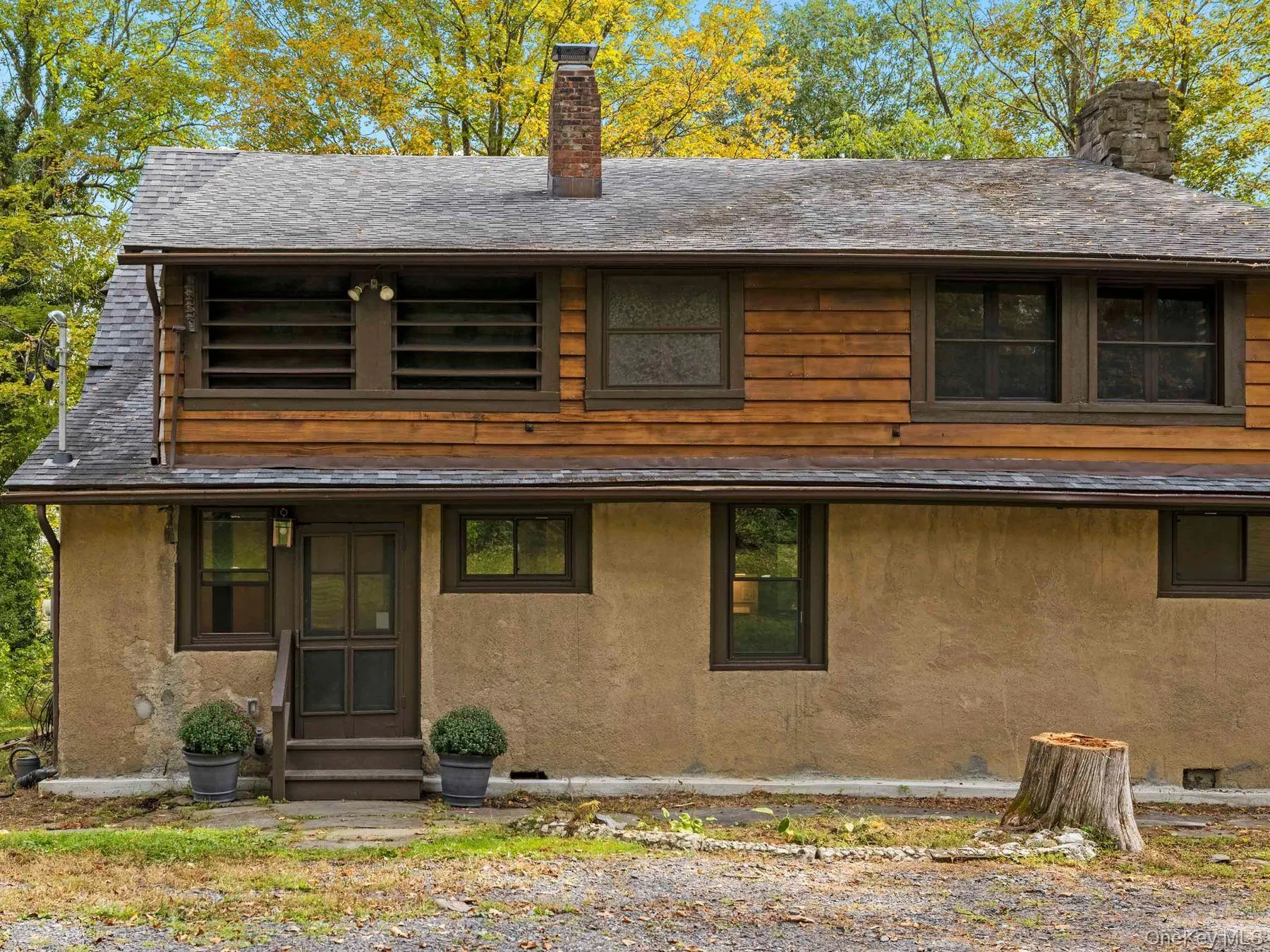 View of front of home featuring a chimney, entry steps, and stucco siding View of front of home featuring a chimney, entry steps, and stucco siding
