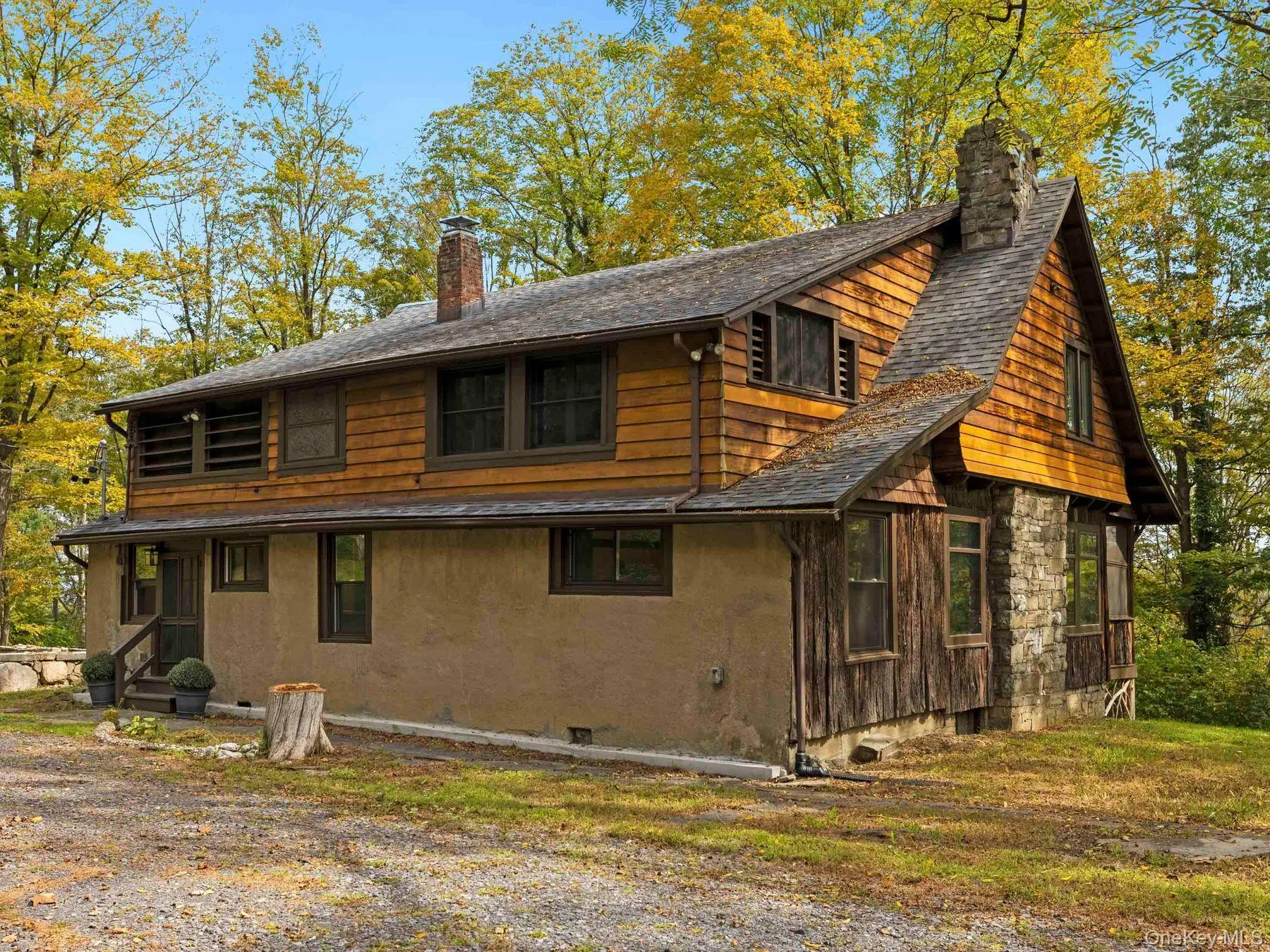 Back of house with a chimney and stucco siding Back of house with a chimney and stucco siding