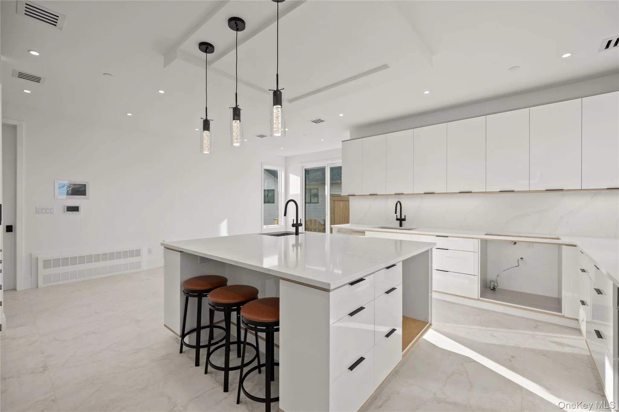 Kitchen featuring hanging light fixtures by the breakfast bar Kitchen featuring hanging light fixtures by the breakfast bar
