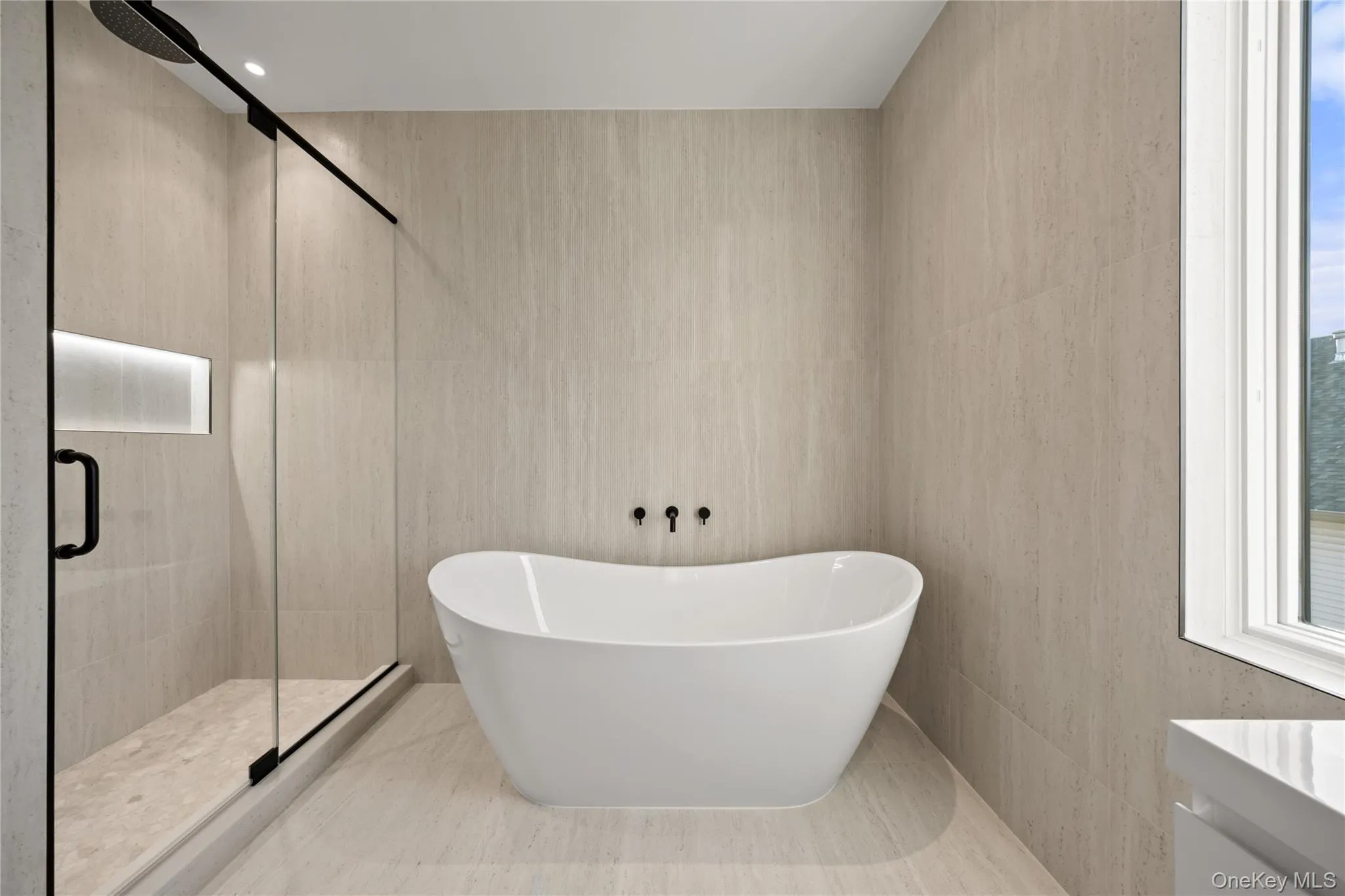 hotel-like spa bathroom featuring freestanding bathtub, and shower with luxury dual showerheads hotel-like spa bathroom featuring freestanding bathtub, and shower with luxury dual showerheads
