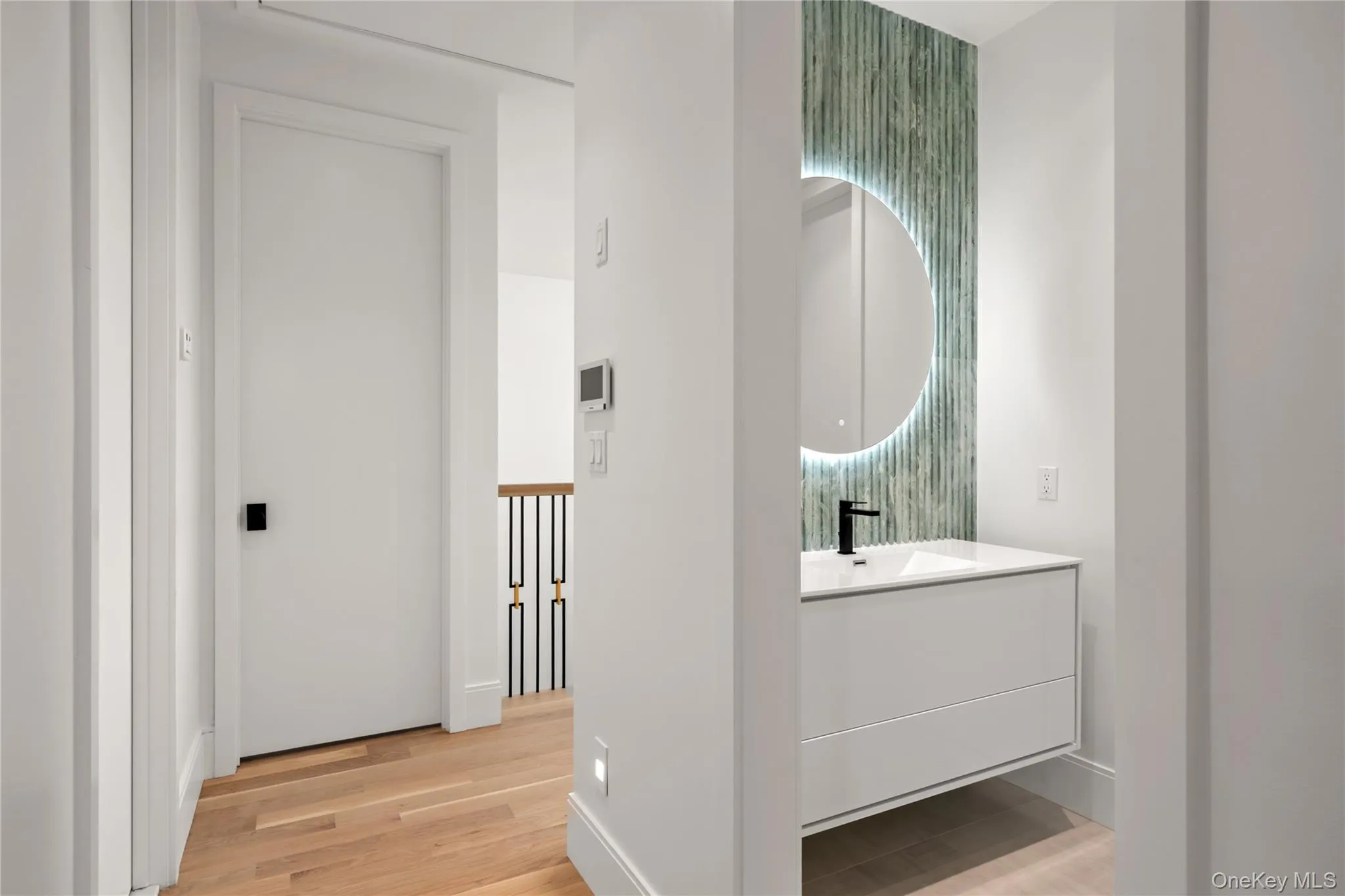 Bathroom featuring LED Backlit Vanity Lighting and tasteful backsplash Bathroom featuring LED Backlit Vanity Lighting and tasteful backsplash