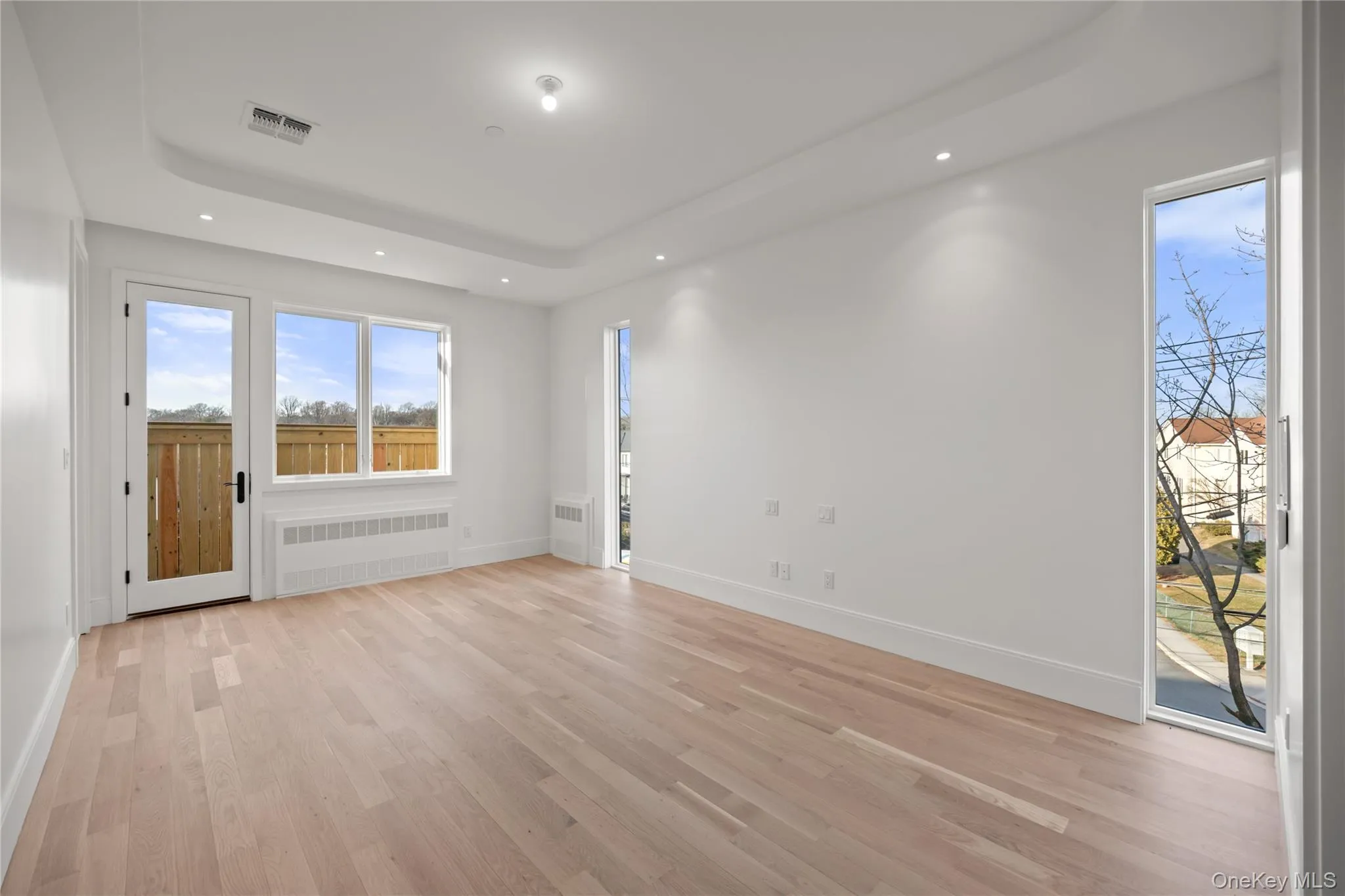 Primary bedroom showcasing floor to ceiling windows Primary bedroom showcasing floor to ceiling windows