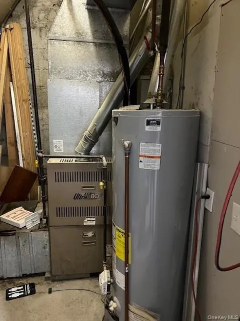 Utility room featuring gas water heater and heating unit Utility room featuring gas water heater and heating unit