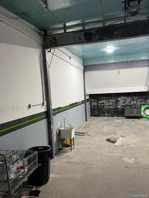 Misc room with a garage and unfinished concrete flooring Misc room with a garage and unfinished concrete flooring