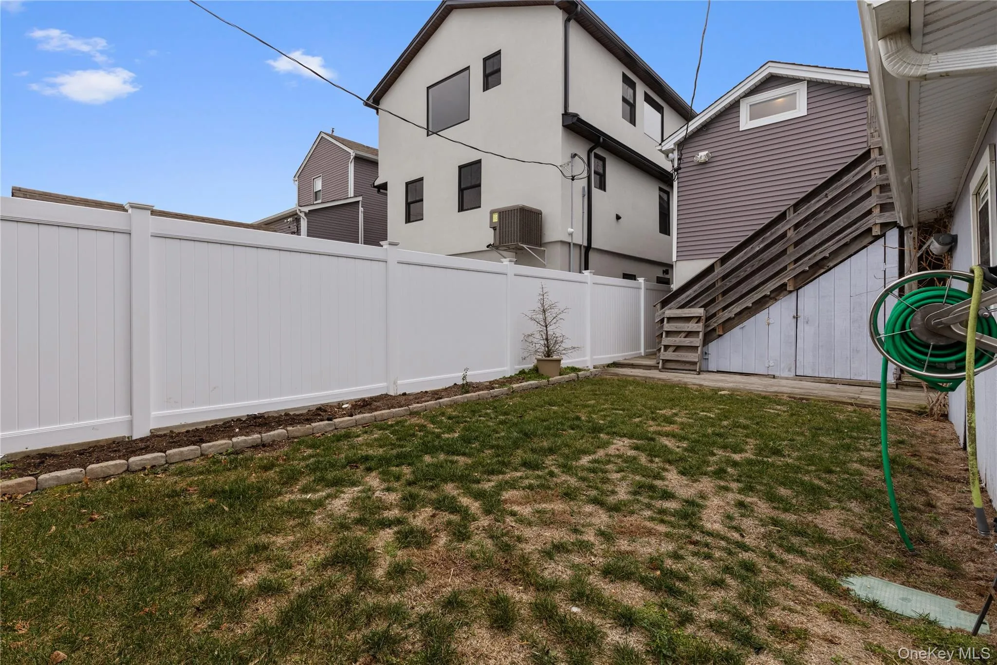Fenced backyard featuring stairs Fenced backyard featuring stairs