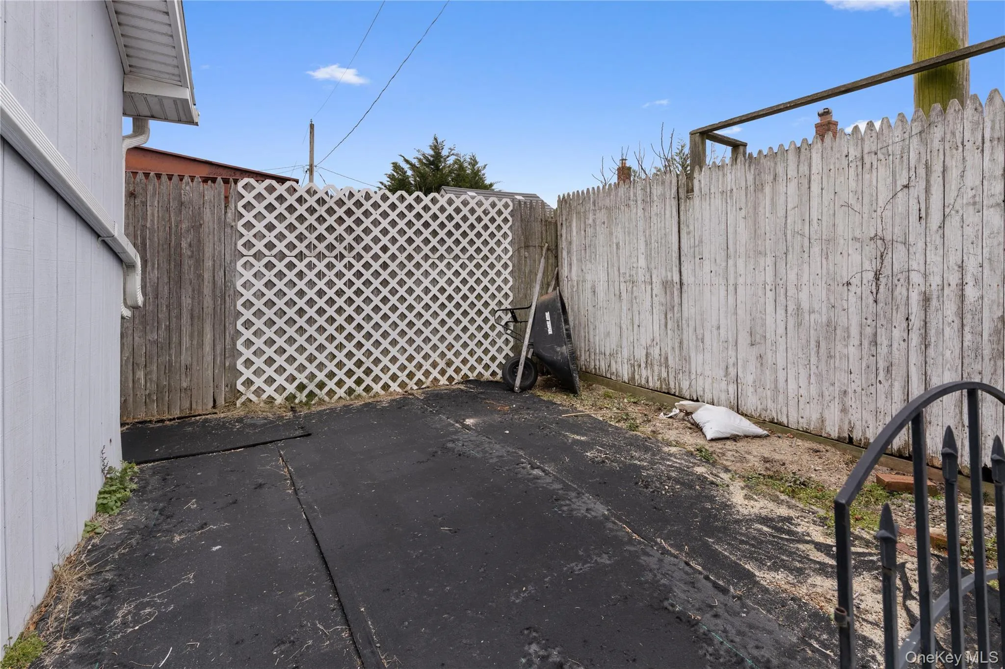 Fenced backyard with a patio area Fenced backyard with a patio area