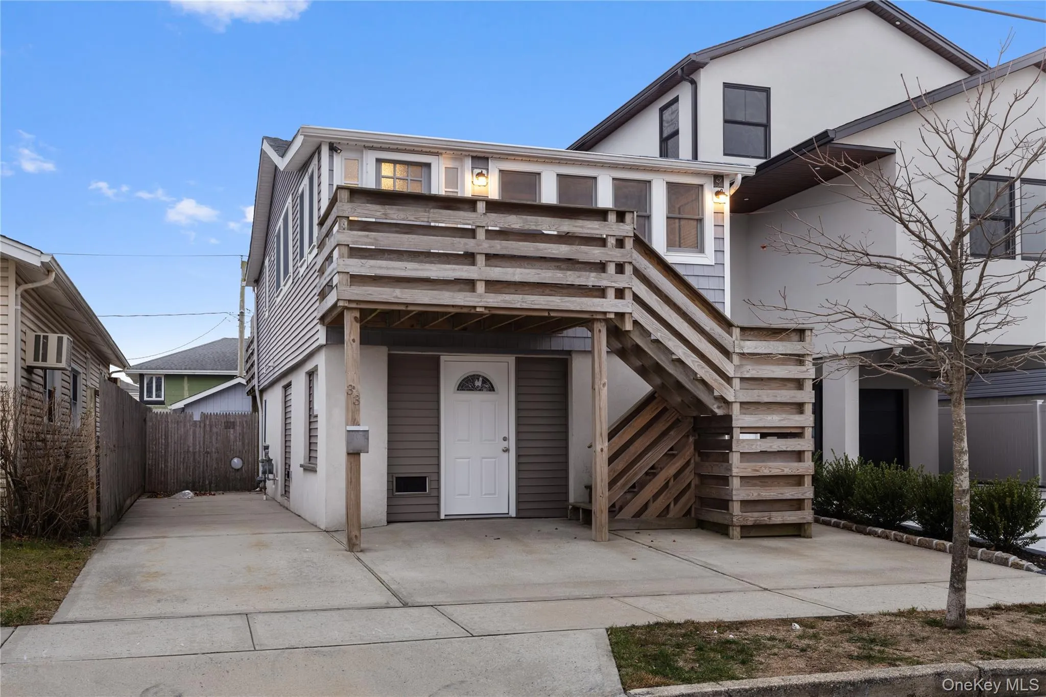 View of front of property with stairs and stucco siding View of front of property with stairs and stucco siding