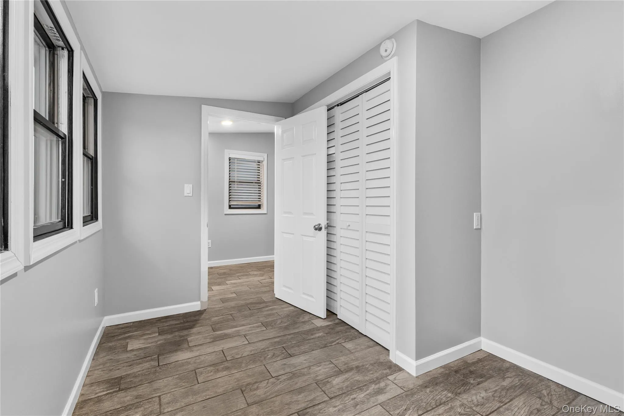 Corridor with wood finished floors and baseboards Corridor with wood finished floors and baseboards