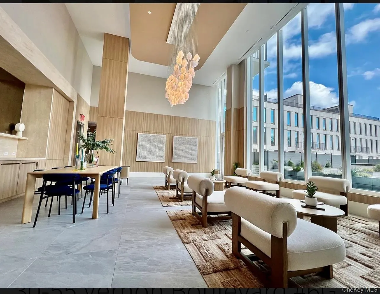 Lobby featuring a towering ceiling and expansive windows Lobby featuring a towering ceiling and expansive windows